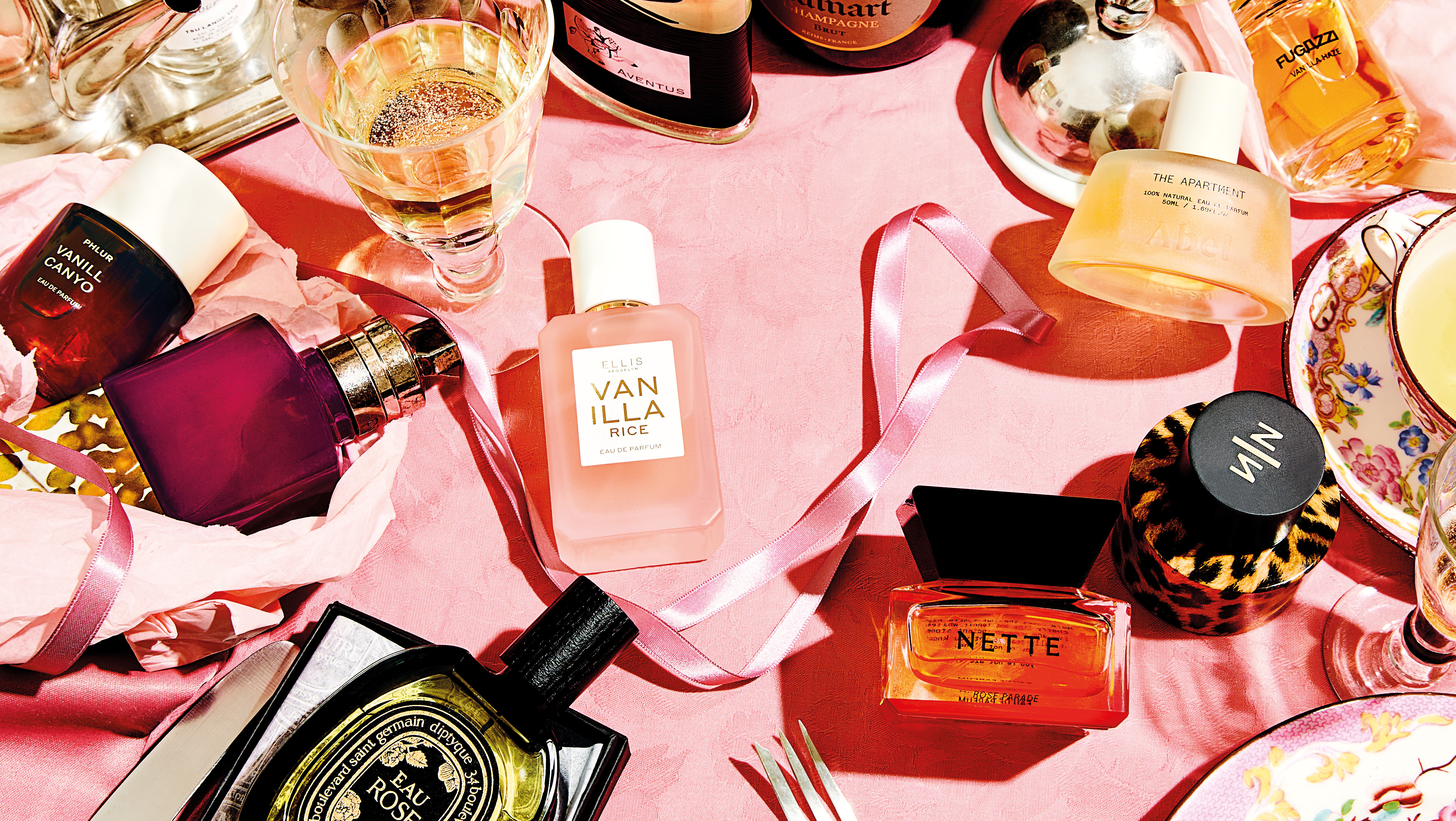 Selection of niche fragrances on a pink background
